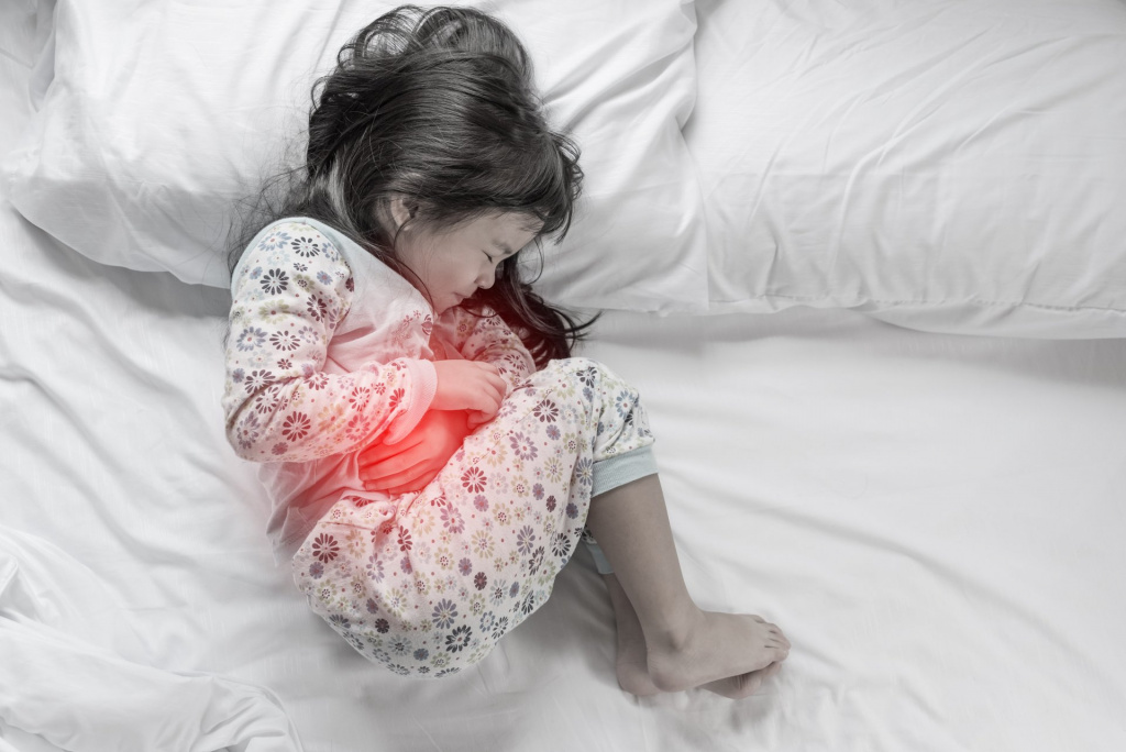 stock-photo-a-little-girl-in-her-bed-has-a-stomachache-522489025.jpg
